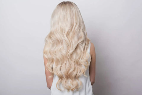 Blonde hair styled with Rotating Curling Iron With 1.25 Inch Ceramic Barrel And Auto Spinning Wand For Effortless Beachy Waves Dual Voltage Travel Friendly Auto Shut Off 290 To 410 F Temperature Range Lightweight Black