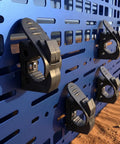 Blue panel with 8 Piece Quick Release Shovel Holder Kit clamps mounted for trucks and SUVs fits roof rack crossbars.