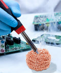 Top Grade Solder Tip Cleaning Brush Made With Heavy Duty Wire Sponge For High Temp Irons cleaning soldering iron on a circuit board.