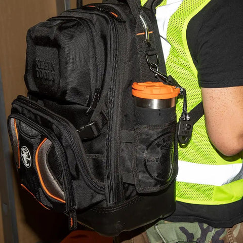 Man carrying a backpack with a Stainless Steel Tumbler With Flip Top Lid 20 Oz Insulated Double Wall Vacuum Mug in side pocket.