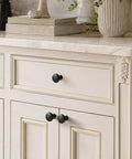 Slick Matte Black Cabinet Knobs Paired With Heavy Duty Smooth Glide Drawer Pulls 25 Pack on cream cabinet with gold trim.