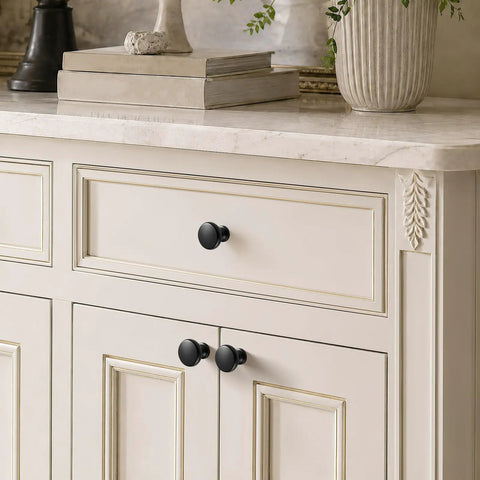 Slick Matte Black Cabinet Knobs Paired With Heavy Duty Smooth Glide Drawer Pulls 25 Pack on cream cabinet with gold trim.