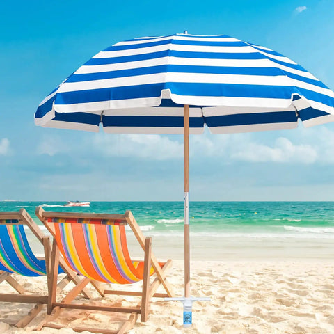 Beach Umbrella Sand Anchor Heavy Duty Base With 5 Spiral Screws Universal Fit For Most Beach Umbrellas Wind Resistant Holder Stand White Durable ABS Plastic That Wont Rust In Sand Or Salt Water set in sand holding a striped blue umbrella on beach.