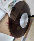 Premium Tempered Glass Lazy Susan Turntable And Slick Swivel Serving Tray with aluminum base on cardboard surface.