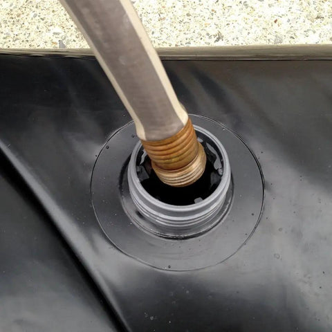 Close-up of a hose filling the Reusable Water-Filled Flood Barrier Curb for Quick Home Flood Defense, Dual-Chamber Design
