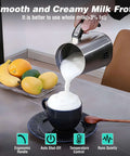 4 In 1 Milk Frother And Steamer For Home Barista-Grade Drinks pouring foam into a cup on a table with fruit