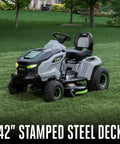 Electric Riding Lawn Mower 42-Inch Deck Cordless Tractor on grass with 42-inch stamped steel deck, 56V battery powered.