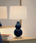 Navy Glass Base Petite Table Lamp With Linen Fabric Shade In White, Satin Nickel Finish, 21.25 Inch Tall on nightstand