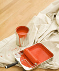 Canvas Drop Cloth 6x9 Feet Pack Of 2 For Painting And Home Projects next to red paint can and roller on wooden floor