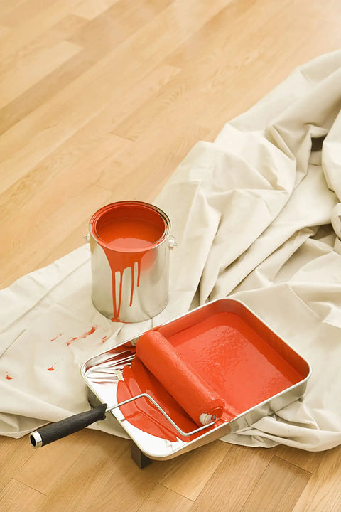 Canvas Drop Cloth 6x9 Feet Pack Of 2 For Painting And Home Projects next to red paint can and roller on wooden floor