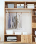 Four Pack White Heavy Duty Closet Rod Brackets And Shelf Supports Great For Wardrobe Storage in a wooden shelving unit with clothes hanging.