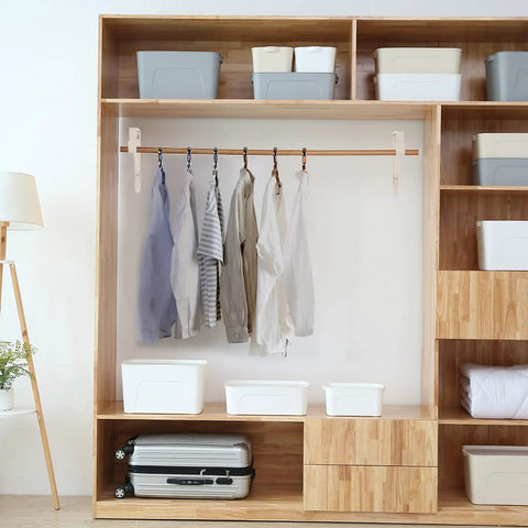 Four Pack White Heavy Duty Closet Rod Brackets And Shelf Supports Great For Wardrobe Storage in a wooden shelving unit with clothes hanging.