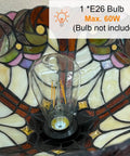 Close-up of the Tiffany Torchiere Floor Lamp With Stained Glass Shade showing bulb socket and intricate glass details.