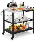 Outdoor Grill Cart 36 Inch Stainless Steel Pizza Oven Table With Lockable Wheels Hooks Adjustable Mesh Side Tray For Seasonings And Tools Paper Towel Holder Mobile BBQ Island Grillin Ready, loaded with kitchen items and fruit.
