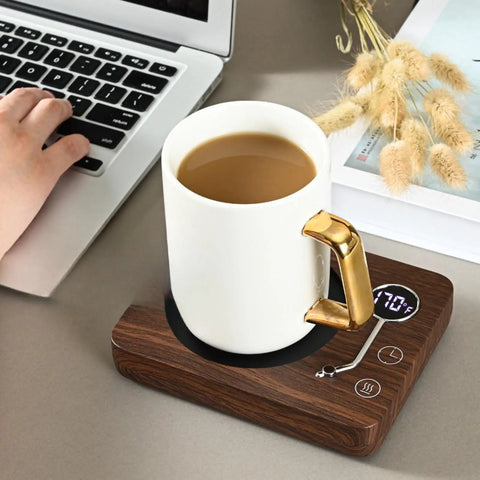 Game Changing Desk Essential Smart Electric Coffee Heated Coaster With Precise Thermostatic Heat Control Adjustable From Forty To Seventy Five Degrees fast warming mug pad with coffee cup on wooden base next to a laptop.