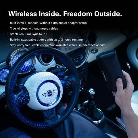 Person holding Rockit Wireless Laser 3D Scanner With 38 Blue Laser Lines inside a car, highlighting wireless capability.