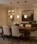 Karjearl Alabaster Pendant Lights Kitchen Island, Modern Gold Hanging Light over a dining table with beige chairs and floral centerpiece.