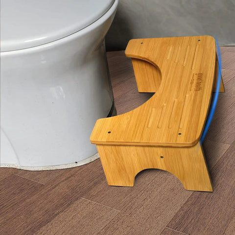 Foldable Bamboo Toilet Stool For Adults, 7.5 Inch Squat Aid next to white toilet, showing bamboo texture and non-slip strip.