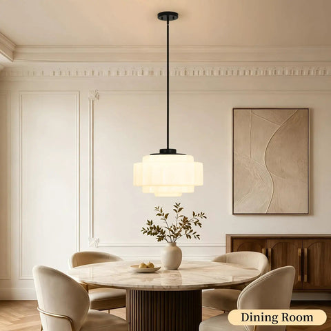 puncoll Vintage Black Milk Glass Pendant Light, 15.7'' White Chandelier hanging above a modern dining table in a bright room.