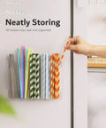 Slick 9.5 Inch Acrylic Straw Organizer Clips Securely To Cabinet Doors With Extra Grippy Adhesive Strips Features Sloped Drainage Base Keeps Countertops Totally Clutter Free And Ready For Use, holding colorful drink straws.