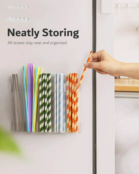 Slick 9.5 Inch Acrylic Straw Organizer Clips Securely To Cabinet Doors With Extra Grippy Adhesive Strips Features Sloped Drainage Base Keeps Countertops Totally Clutter Free And Ready For Use, holding colorful drink straws.