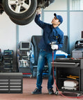 Mechanic using Five Drawer Rolling Tool Chest With Removable Tool Cabinet And Sliding Metal Organizer in garage with car lifted.