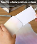 Hands placing Chic Letter Paper Set With Envelopes 8.18 By 5.5 Inch Size 30 Letter Sheets And 18 Envelopes into an envelope