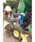 Using Heavy Duty 500 CC Lever Grease Gun For Bulk Or Cartridge Loading on farm machinery, hydraulic connector visible.