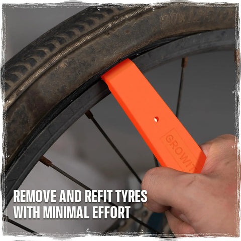 Heavy Duty Bike Tire Levers Two Pack With Steel Core And Anti Slip Grip For Mountain Road And BMX Bikes Tubeless Tire Tools Pro Grade And Unbreakable Orange For Tubeless Tire Setup And Quick Roadside Repairs On Any Ride being used to remove tire