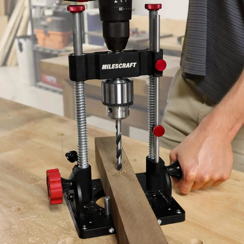 Beefy Pro Grade Portable Drill Press Drilling Guide With One Half Inch Chuck, shown in use on wooden plank in workshop.