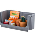 Heavy Duty Open Front Storage Bins For Garage And Home Organization, Jumbo Stackable Bins With Large Handles, Interlocked Secure Stacking, Rust Resistant Plastic, Made In USA, Gray filled with gardening supplies