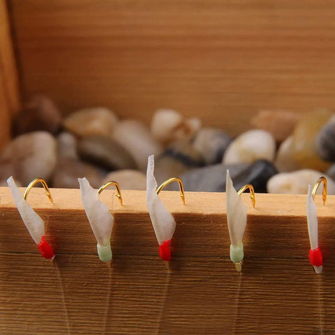 Glow In The Dark Saltwater Fishing Bait Rig Set 15 Pack With Real Fish Skin Sharp Hooks on wooden background