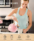 Woman using Pink Stainless Steel Tea Kettle For Stove Top 2.6 Qt Whistling Kettle With Wood Pattern Folding Handle in kitchen