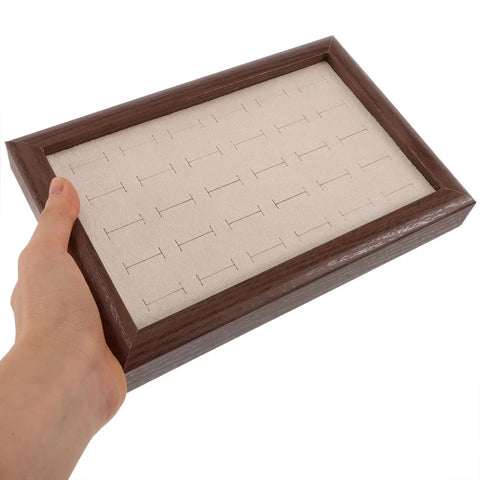 Solid Wood Earring Organizer And Ring Keeper Tray With Thirty Open Slots For Stashing Bracelets And Chains In A Rich Walnut Finish held in hand.