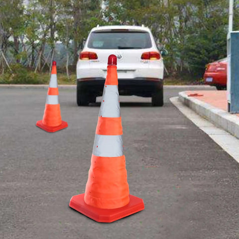 4 Pack 27.6 Inch Collapsible Traffic Cones With Nighttime LED Lights used beside parked cars on a roadside
