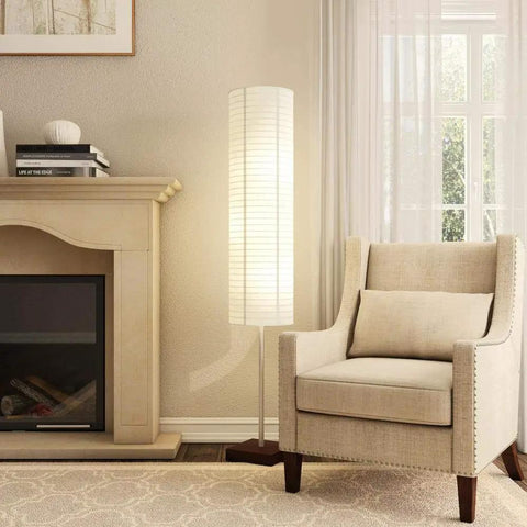 Gyoza Floorchiere Floor Lamp Tall 67 Inch Standing Light in a living room with walnut rubber wood base, white rice paper shade next to armchair.