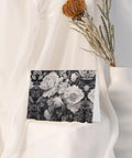 Floral Graphite Print Greeting Cards Half Fold 4x6 Inches displayed against white fabric with dried flowers.