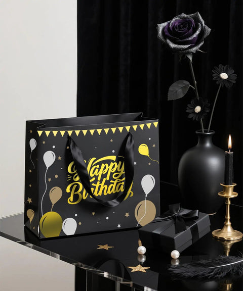 Black Birthday Gift Bag For Men With Foil Stamping And Tissue Paper, 12.5 Inch Medium Gift Bag With Greeting Card on a table.