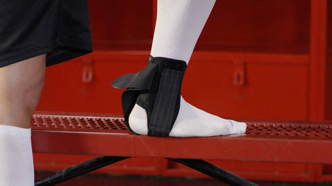 Stealth Lace-Free Ankle Brace For Left Or Right Ankles on foot, ultra lightweight support with flex-support stays, secure cleat fit.