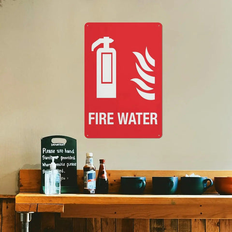 Built Tough Fire Water Supply Caution Sign 8 By 12 Inch No Rust Nonsense Reflective Aluminum Warning Plate on a wall with fire extinguisher graphic.