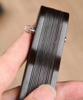 Close-up of a hand holding a 25mm copper shaft fastener from the Hand Fan Repairing Kit for folding fans.
