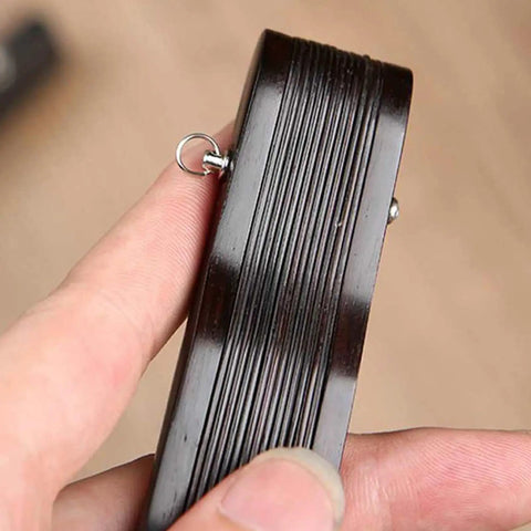 Close-up of a hand holding a 25mm copper shaft fastener from the Hand Fan Repairing Kit for folding fans.