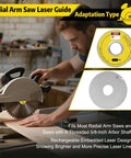 Front view of a rechargeable radial arm saw laser guide installed on a saw; bright yellow laser module and silver disc.