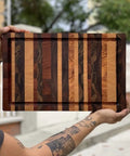 Hands holding a wooden cutting board outdoors, treated with Cutting Board Oil For Wood And Butcher Block, 32 Oz Jug, FDA Food Contact Safe