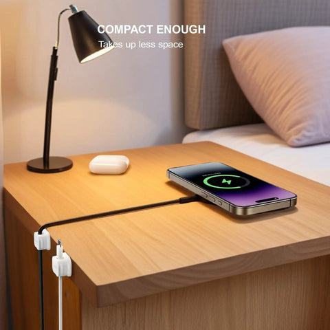 Magnetic Cable Clip Organizer Pack For Car Desk Nightstand And Wall Mount Adhesive Cord Holder Keeps USB Cables And Chargers Neat No Mess 0.3 Inch Slot Fits Most Cables Wire Keeper For Home Office shown holding phone cable on nightstand.