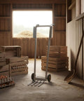 Manual Egg Cart Two Wheel Hand Truck With Front Crate Prongs, Heavy Duty Utility Push Cart Metal Frame, Black Grip Handles, Stable Handling For Stockrooms, Warehouses, Distribution Centers, And Supply Rooms in a barn with egg crates