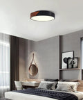 Slick Modern Black Wood Look Flush Mount Ceiling Light 3 Light Fixture in stylish bedroom setting