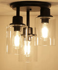 Three Light Matte Black Dope Semi Flush Mount Ceiling Light With Clear Glass Shades installed for rustic industrial style room