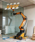 Beefy Electric Glass Vacuum Lifter With Remote Controlled Suction Cup Robot For Zero Sweat Heavy Panel Handling And Top Notch Factory Or Construction Site Performance, showcasing the lifter in action with glass panels.