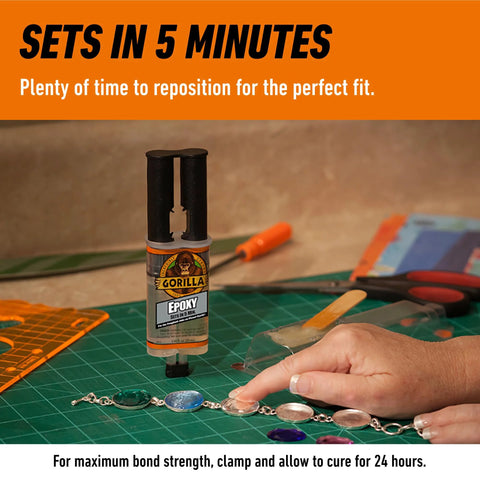 Front view: Gorilla 2-Part Epoxy syringe, clear epoxy, 0.85 oz, orange cap on crafting workspace